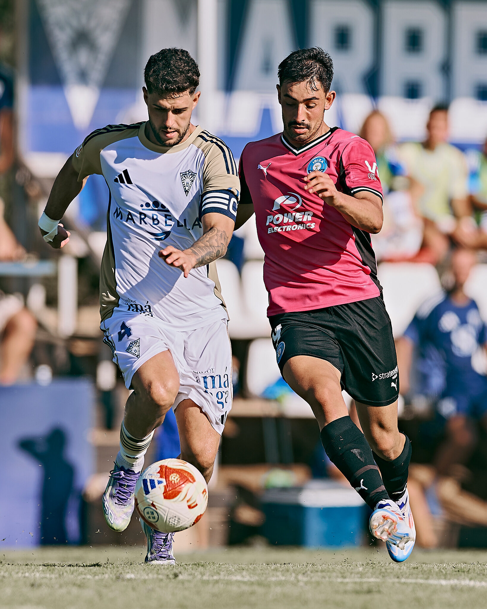 Davo compite con potencia contra el capitán rival del Marbella en una carrera por el balón.